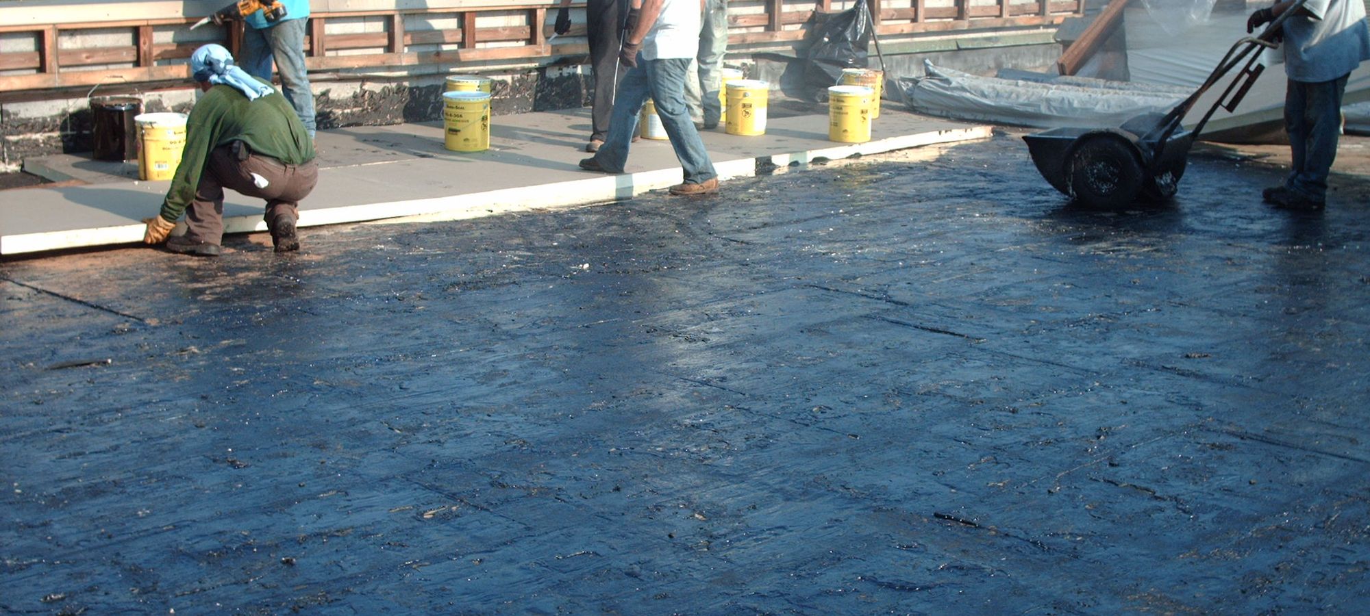 Frank Stevens and Sons crew installing a built-up hot tar roof system