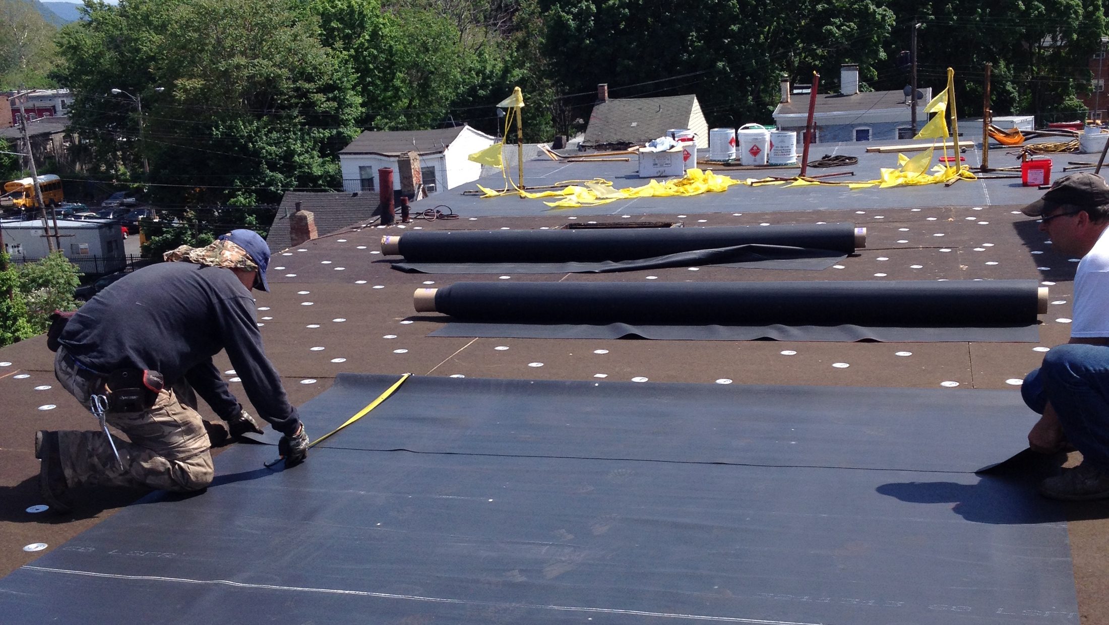 Frank Stevens and Sons crew installing a rubber membrane roof in the Hudson Valley