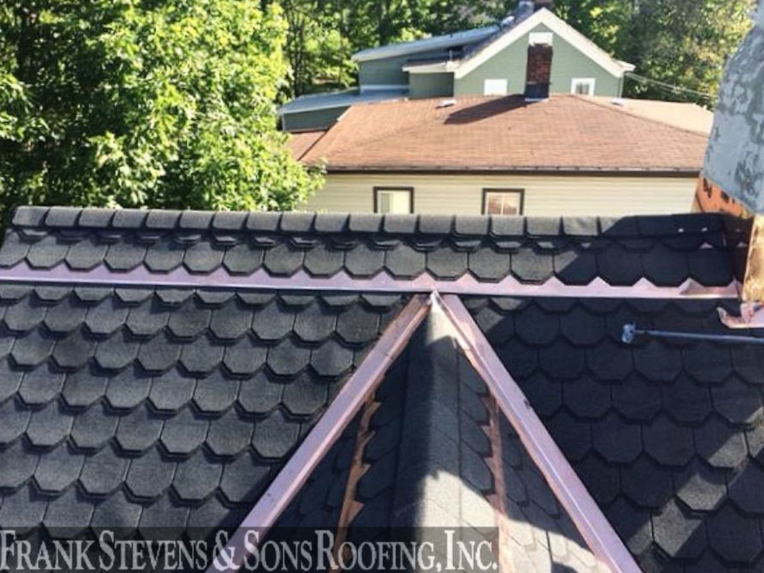 Scalloped designer GAF shingles with copper valleys
