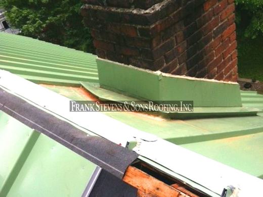 Standing seam metal roof flashing at a chimney